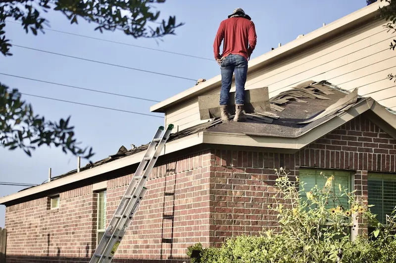 Professional roofer working on a residential roof in North Woodbury